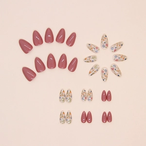 Short almond press-on nails with dusty rose colors and delicate floral painted patterns