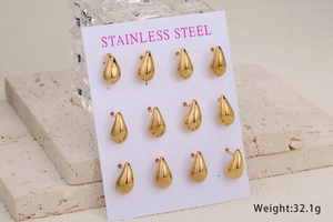 Set of 6 pairs of chunky golden stainless steel water drop stud earrings on a display card