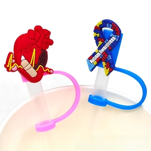 Detailed view of medical silicone straw covers featuring heart and autism awareness designs
