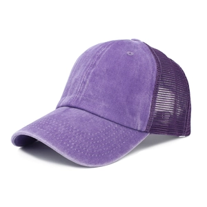 Detail of purple washed cotton baseball cap featuring breathable mesh and curved brim