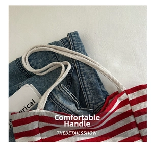 Detail of red and white striped canvas tote bag with thick cream rope handles