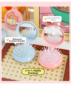 Detail of cute cartoon foldable hairbrush and mirror set in pink and blue pastel colors