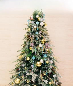 Detail display of crystal acrylic snowflakes and icicles hanging on a Christmas tree