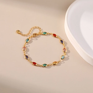 Detail of 18K gold-plated chain bracelet with colorful oval acrylic stones and lobster clasp
