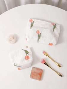 Elegant white seersucker cosmetic bag set with orange tulip embroidery for skincare storage