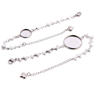 Macro view of stainless steel dolphin bracelet base with round tray and heart pendant