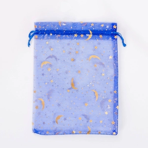 Detailed view of blue organza pouch with gold star and moon patterns and drawstring closure