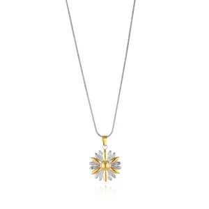 Close-up of a two-tone daisy flower pendant on a sleek silver snake chain necklace