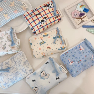 Detailed macro view of assorted mini cotton pouches with cute cartoon animal patterns