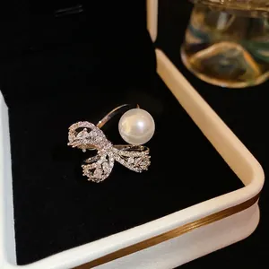 Minimalist silver open ring with zircon bow and white pearl in jewelry gift box