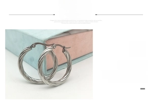 Detail of silver twisted hoop earrings made of durable polished stainless steel