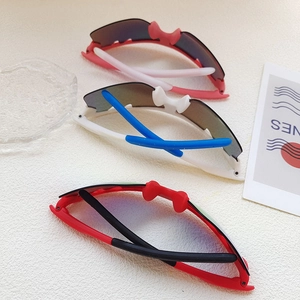 Three pairs of kids sports sunglasses in pink, blue, and black with silicone nose pads