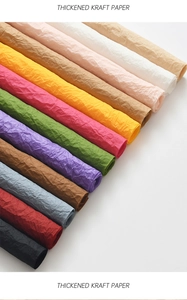 Detailed texture of thick wrinkled kraft paper rolls in yellow, red, and purple colors