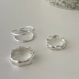Detailed view of 925 sterling silver minimalist ring set with polished geometric textures