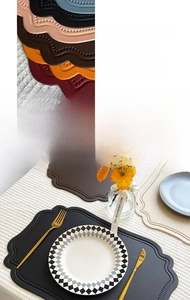 Detail of scalloped edge faux leather placemats with heat-pressed anti-fray texture