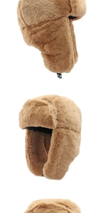 Detail view of brown faux fur trapper hat with adjustable chin buckle and ear flaps