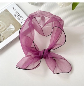Detail of purple organza neck scarf showing delicate black stitched edges and texture