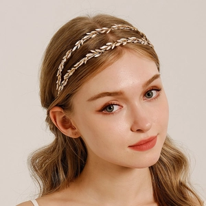 Detail of baroque gold metal headband with multilayered leaf design and pearls