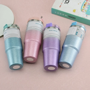 Top view of four 30oz glitter gradient vacuum insulated tumblers on a pink desk