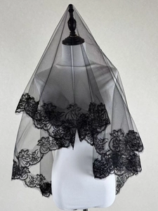 Detailed close-up of double-layer black mesh bridal veil with intricate lace edge embroidery