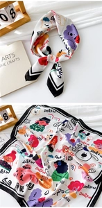 Detail of white satin square scarf featuring colorful cartoon bear and girl prints