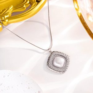 Silver stainless steel snake chain necklace with a square shell pearl pendant on stone