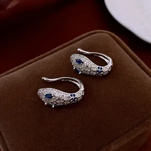 Luxurious snake ear cuff with white zircon stones and deep blue gemstone eyes