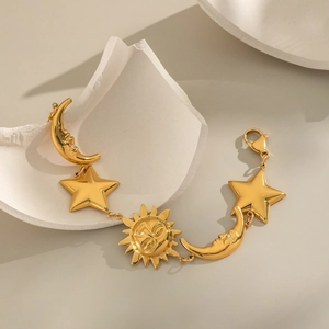 Golden sun moon and stars charm bracelet with a polished celestial pendant design
