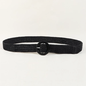 Bohemian black woven belt with a round buckle on a minimalist textured surface