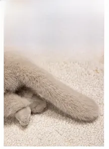 Close-up of fluffy warm beige Persian cat plush fabric showing soft hair texture