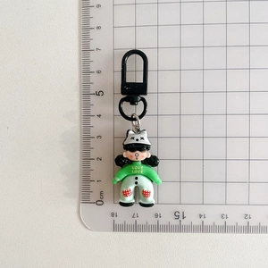 Cartoon puppet keychain with size measurement showing 4cm height in green hoodie