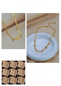Detail showing various gold snake chains with turquoise butterfly and embossed pendants