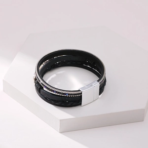Detail of multi-layer woven leather bracelet with blue beads and silver magnetic clasp