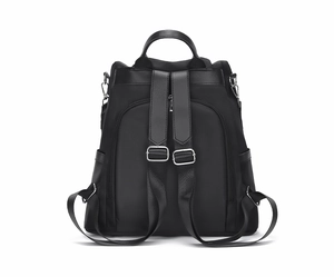 Rear view of black nylon backpack featuring adjustable straps and a secure back zipper pocket