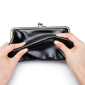 Retro black leather kiss-lock wallet showcasing its soft texture and flexible quality