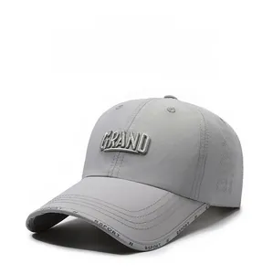 Macro shot of grey quick-dry baseball cap with GRAND embroidery and breathable mesh side