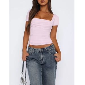 Close-up of pink short-sleeved top featuring a square neckline and ruched chest detail