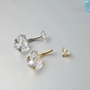 Detail of heart-shaped zircon belly rings with 14G internal thread and screw ball