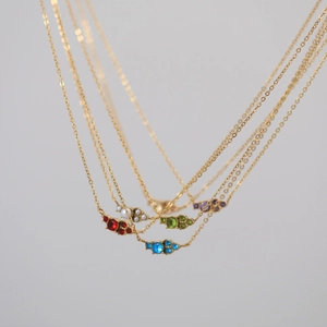 Gold plated stainless steel birthstone necklace with vibrant cubic zirconia pendant gems