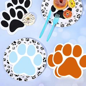 Detail of dog paw printed paper plates and napkins for pet themed birthday party decor