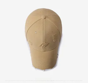 Top view of khaki vintage distressed baseball cap with gold embroidery and frayed details