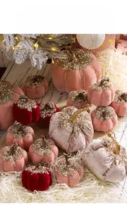 Detail of velvet pumpkin decor with golden sequins in a festive Christmas setting