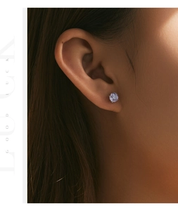 Macro view of a 925 sterling silver ear stud with rose-cut purple amethyst and cz diamond