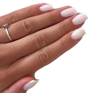 French tip press-on nails with light pink base and glossy white finish on model hand