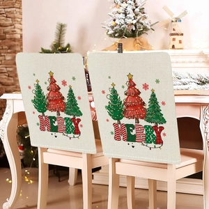 Detail of Christmas chair covers with Merry text and rustic linen texture in a festive room