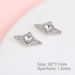 Detailed view of silver heart angel wing charms with 20x11mm dimensions and zircon inlay