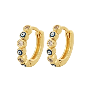 Detalle de pendientes de aro dorados con diseño de ojo turco y cristales de circonita
