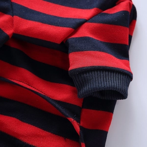 Close-up of ribbed cuffs and red and black striped fabric on dog pajama sleeves