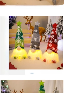 Three glowing Christmas gnomes with knitted snowflake hats and LED lights on a bench