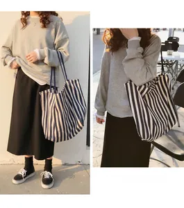 Detail of navy stripe canvas tote bag showing large capacity and soft fabric texture